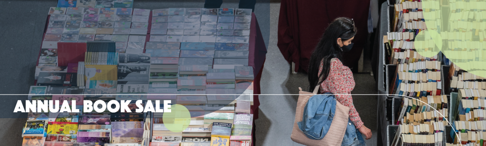 woman looks at books at a book sale