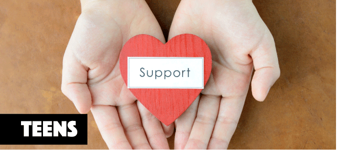 cupped hands holding a paper heart the says "support"