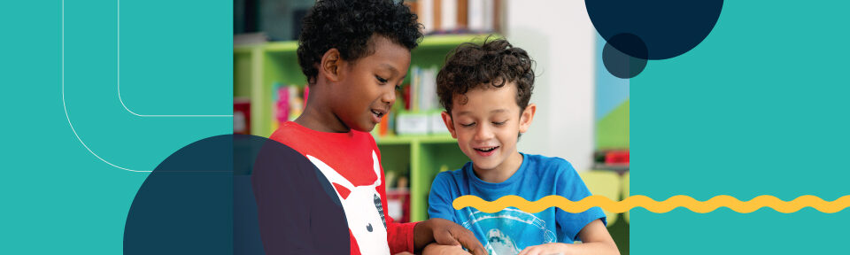 two young boys play with toys at a table in a children's library