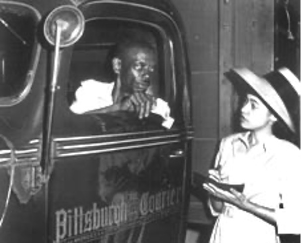 A Black reporter interviews a delivery driver from the Pittsburgh Courier