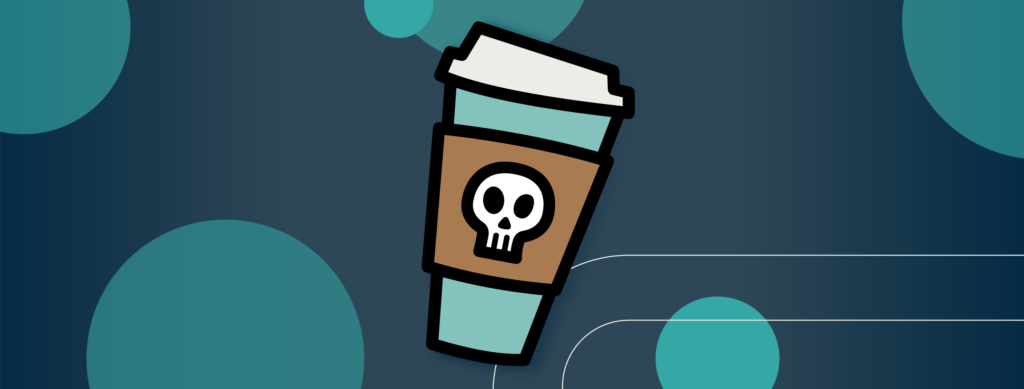 A to-go cup of coffee with a skull on the sleeve