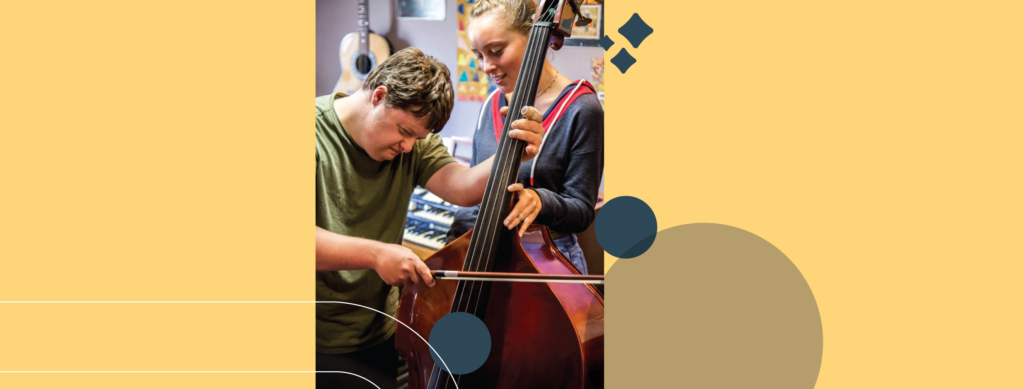 Musician playing an instrument with a volunteer