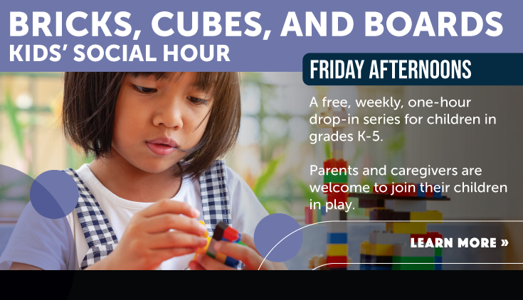 Young girl plays with Legos at a Friday afternoon Bricks, Cubes, and Boards event at the downtown library.