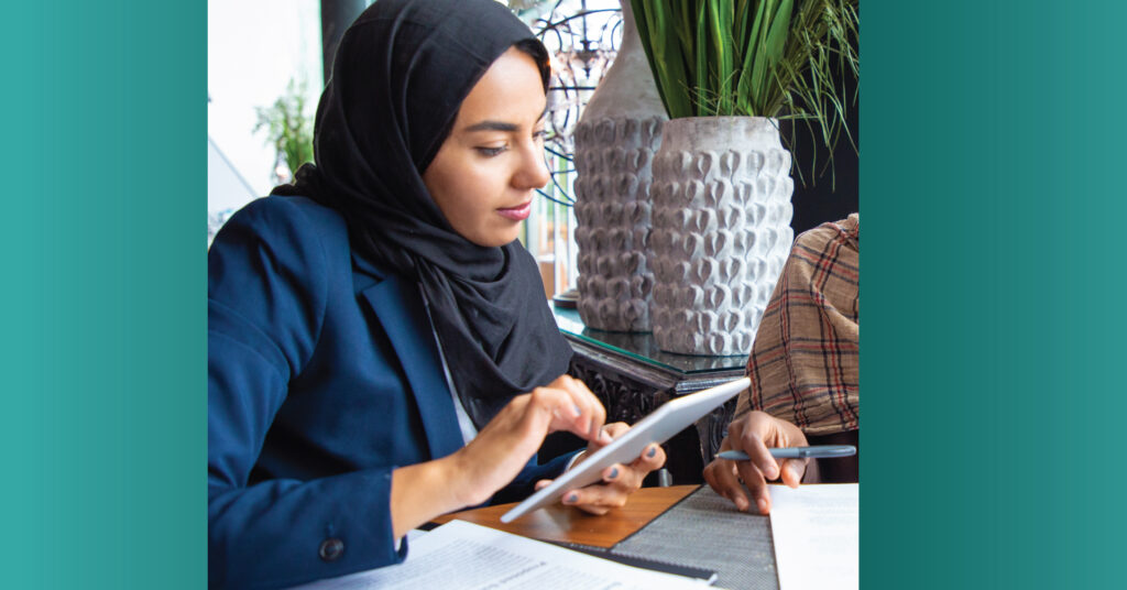 Decorative image of an Arabic woman working on a tablet