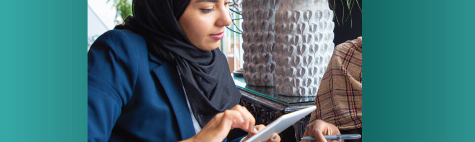 Decorative image of an Arabic woman working on a tablet