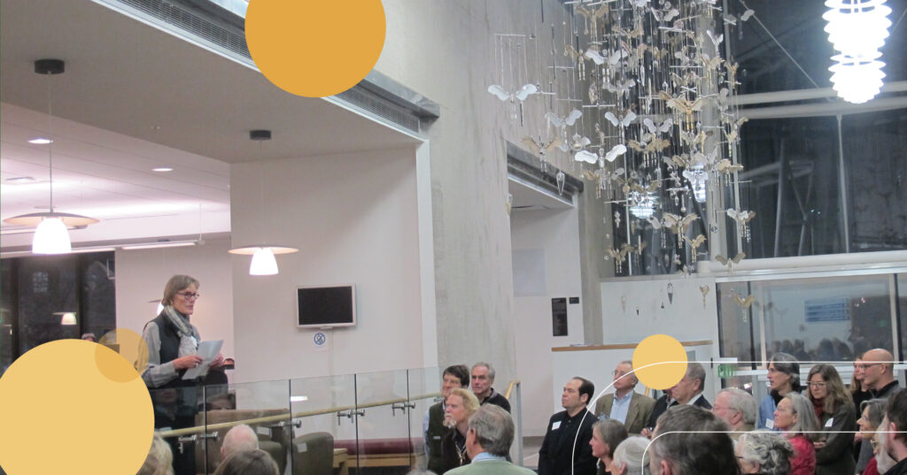 Alison Hildreth with her piece at the Downtown Library, "The Feathered Hand"