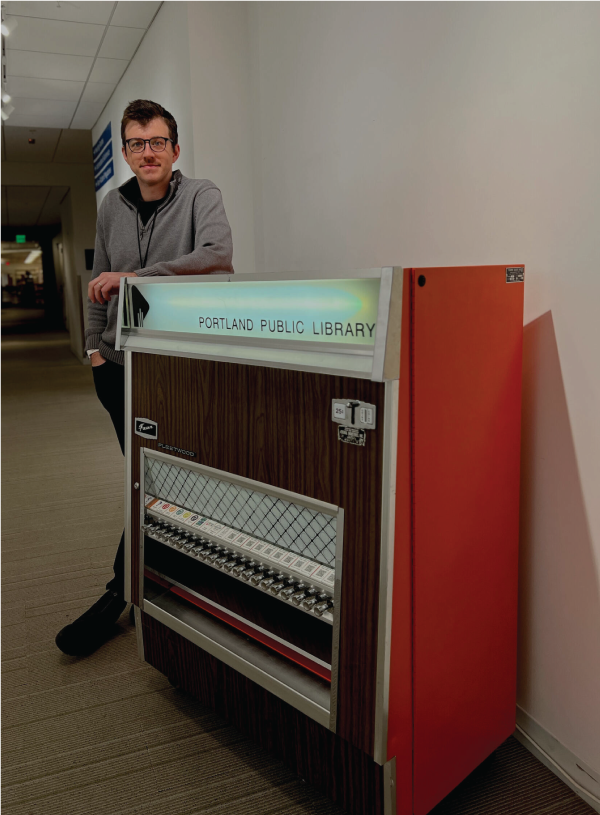 Cy stands with the restored vending machine