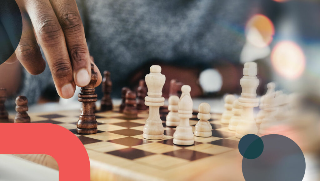 A hand places a piece on a chess board