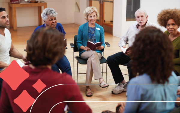 a group of people sit in a circle discussing a book